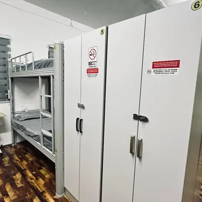 a row of lockers in a room with a bed at Hey Rest Up with shared bathroom in Ipoh