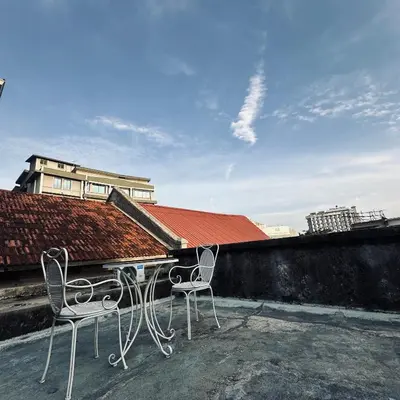 two chairs and a table on top of a roof at Hey Rest Up with shared bathroom in Ipoh