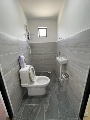 a bathroom with a toilet and a sink at Ling Dream Home in Sitiawan in Sitiawan