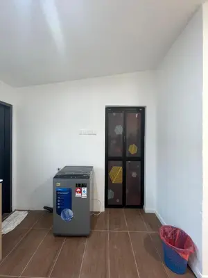 a room with a refrigerator in the corner of a room at Ling Dream Home in Sitiawan in Sitiawan