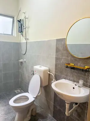 a bathroom with a toilet and a sink at Hana Homestay Seri Iskandar in Seri Iskandar