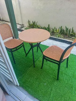 two chairs and a table and two tables and chairs at Hana Homestay Seri Iskandar in Seri Iskandar