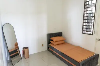 a small bedroom with a bed and a mirror at Leavy Haven, Botanica CT, Balik Pulau, Penang in Balik Pulau
