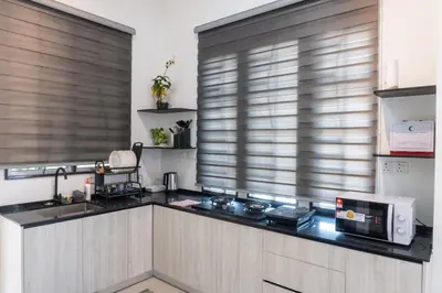 a kitchen with a sink and a microwave at Leavy Haven, Botanica CT, Balik Pulau, Penang in Balik Pulau