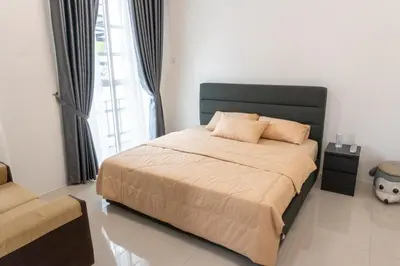 a bedroom with a large bed with a large window at Leavy Haven, Botanica CT, Balik Pulau, Penang in Balik Pulau