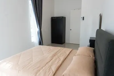a bedroom with a bed and a couch and a window at Leavy Haven, Botanica CT, Balik Pulau, Penang in Balik Pulau