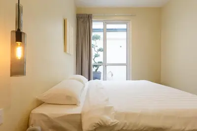 a white bed in a room with a window at De Luma-Cozy 2Bedroom Landed House, Bukit Mertajam in Bukit Mertajam