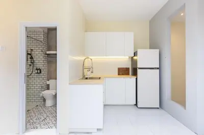 a white kitchen with a sink and a refrigerator at De Luma-Cozy 2Bedroom Landed House, Bukit Mertajam in Bukit Mertajam