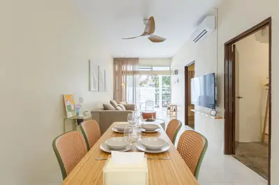 a dining room with a wooden table and chairs at De Luma-Cozy 2Bedroom Landed House, Bukit Mertajam in Bukit Mertajam