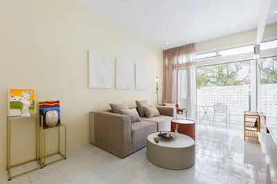 a living room with a couch and a table at De Luma-Cozy 2Bedroom Landed House, Bukit Mertajam in Bukit Mertajam