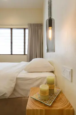 a bedroom with a bed and a table with two dishes on it at De Luma-Cozy 2Bedroom Landed House, Bukit Mertajam in Bukit Mertajam