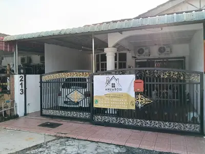 a sign on a gate in front of a house at Anuarosi Homestay Taman Melor, Teluk Intan in Teluk Intan