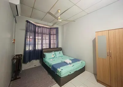 a small bedroom with a bed and a window at Anuarosi Homestay Taman Melor, Teluk Intan in Teluk Intan