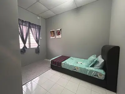 a small bedroom with a bed and a window at Anuarosi Homestay Taman Melor, Teluk Intan in Teluk Intan