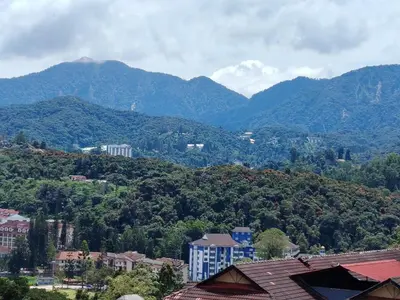 a view of a city with mountains in the background at Holiday Bungalow Guesthouse in Tanah Rata