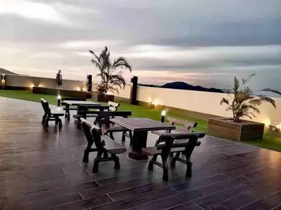 a group of picnic tables on a roof at night at The Venus Sweet home in Sitiawan