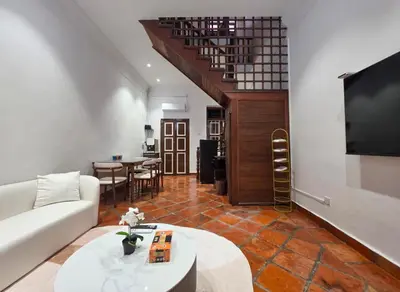 a living room with a couch and a tv at New ! 6 Pax Georgetown Heritage Pre-war House 2 Bed Room in George Town