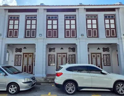 two cars parked in front of a building at New ! 6 Pax Georgetown Heritage Pre-war House 2 Bed Room in George Town