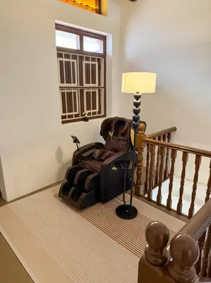 a room with a chair sitting on the stairs at New ! 6 Pax Georgetown Heritage Pre-war House 2 Bed Room in George Town