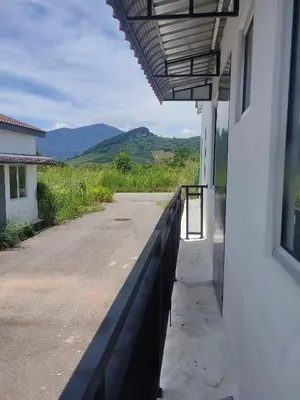 a balcony of a building with a view of the mountains at Homestay Saujana Hill in Gua Musang