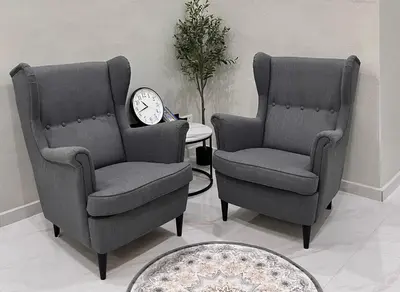 two chairs and a clock in a living room at Peruda Inn - Homestay for Múslim only in Sungai Petani
