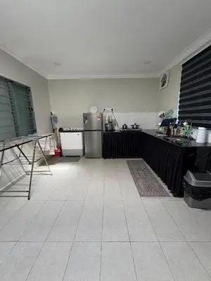 a kitchen with a counter top and a refrigerator at Peruda Inn - Homestay for Múslim only in Sungai Petani