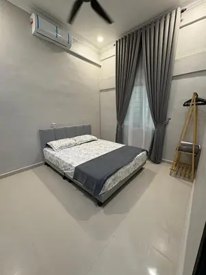 a bedroom with a bed in a room with a window at Peruda Inn - Homestay for Múslim only in Sungai Petani
