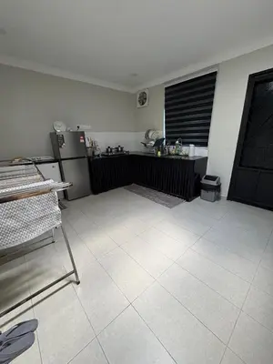 a kitchen with a refrigerator and a tiled floor at Peruda Inn - Homestay for Múslim only in Sungai Petani