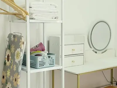 a white shelf with a mirror and a dressing table at Ipoh Cove Hillside Mini Waterpark Family Suite in Ipoh