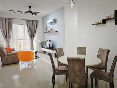 a living room with a table and chairs at Ipoh Cove Hillside Mini Waterpark Family Suite in Ipoh