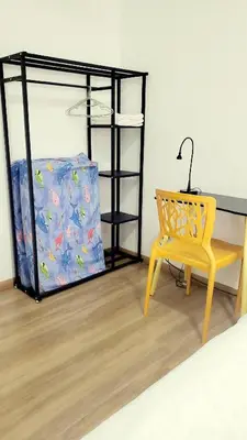 a desk and a chair in a room with a bed at Ipoh Cove Hillside Mini Waterpark Family Suite in Ipoh