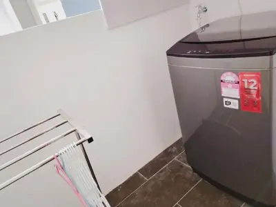 a trash can in a room with a bench at Ipoh Cove Hillside Mini Waterpark Family Suite in Ipoh