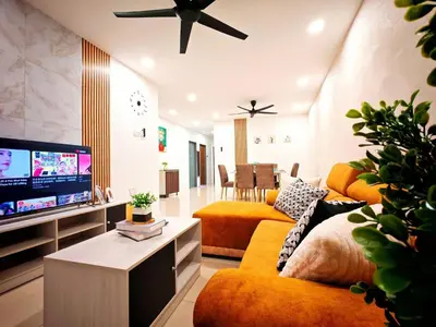 a living room with orange furniture and a flat screen tv at Ipoh Manhattan Free Waterpark 3BR 8Pax Family Suite MHA306 by City Home Empire in Ipoh