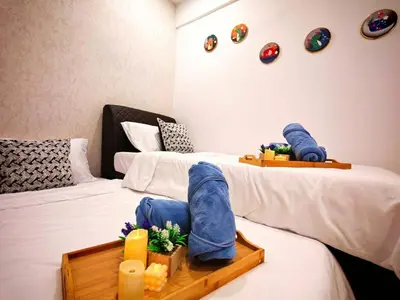 a room with two beds with a tray on the bed at Ipoh Manhattan Free Waterpark 3BR 8Pax Family Suite MHA306 by City Home Empire in Ipoh
