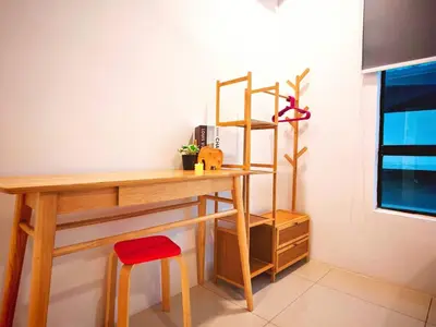 a wooden desk with a red stool and a shelf at Ipoh Manhattan Free Waterpark 3BR 8Pax Family Suite MHA306 by City Home Empire in Ipoh