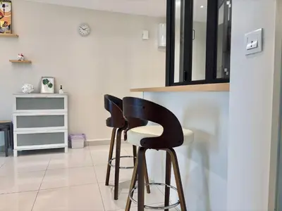 two black and white bar stools in a kitchen at D'Festivo Residence Ipoh 3Bdr by PLY Home in Ipoh