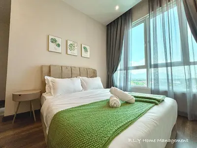 a bedroom with a bed with a green blanket and a window at D'Festivo Residence Ipoh 3Bdr by PLY Home in Ipoh