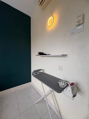 a ping pong table in a room with a green wall at Sri Sayang sunset 2 bedroom in Batu Ferringhi