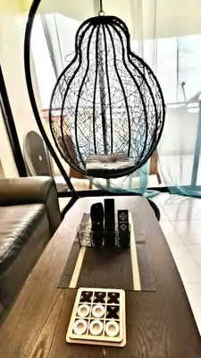 a table with two remote controls and a lamp at Sri Sayang sunset 2 bedroom in Batu Ferringhi