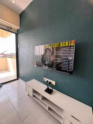 a living room with a bench and a poster on the wall at Sri Sayang sunset 2 bedroom in Batu Ferringhi