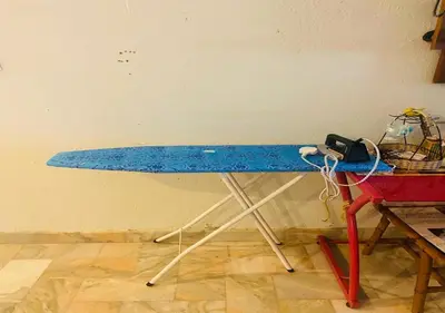 a blue surfboard on a table against a wall at Robina Homestay in Butterworth