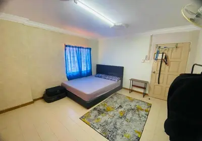 a bedroom with a bed and a door with a rug at Robina Homestay in Butterworth