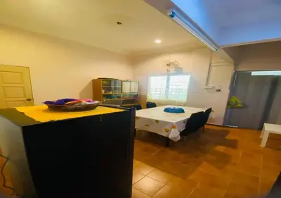 a living room with a table and a dining room at Robina Homestay in Butterworth