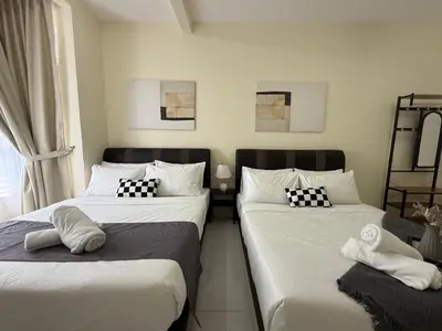two beds in a room with white sheets and pillows at Cozy 3BR Emerald Avenue Brinchang, 8pax Netflix in Brinchang
