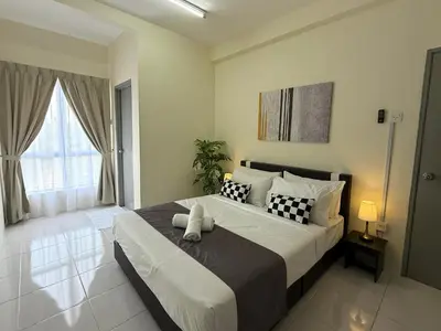 a bedroom with a large bed with black and white pillows at Cozy 3BR Emerald Avenue Brinchang, 8pax Netflix in Brinchang