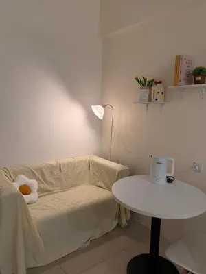 a living room with a couch and a table at Cozy Inn Homestay in Kampar