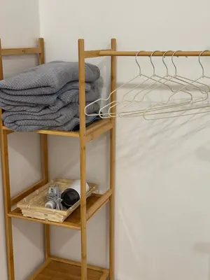 a shelf in a room with a bed at Cozy Inn Homestay in Kampar