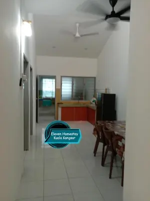 a kitchen and dining room with a table and chairs at Eleven Homestay Kuala Kangsar in Kuala Kangsar