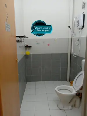 a bathroom with a toilet and a sign on the wall at Eleven Homestay Kuala Kangsar in Kuala Kangsar