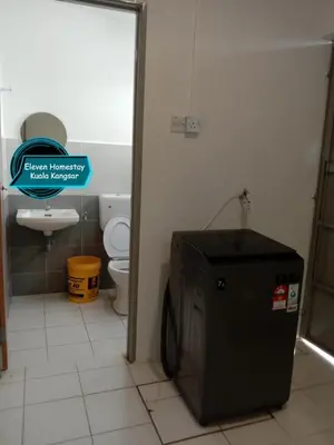 a bathroom with a toilet and a tv in it at Eleven Homestay Kuala Kangsar in Kuala Kangsar